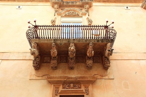 Old town of the late Baroque city of Noto in the Val di Noto, balcony at Palazzo Nicolaci di