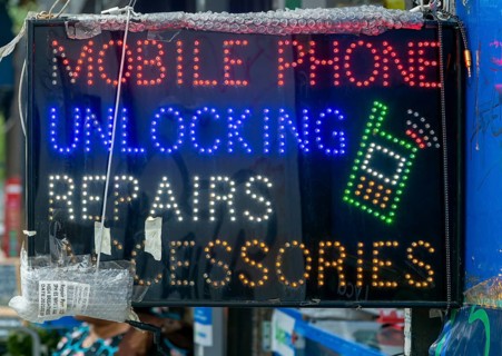 Neon electric sign for Mobile Phone Unlocking Repairs Accessories, Deptford High Street, London