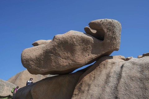 Tourists visiting strange rock formations due to wind and water erosion along the Côte de granit