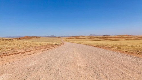 Gravel road C14, in the background the Tiras Mountains, Namibia, Africa