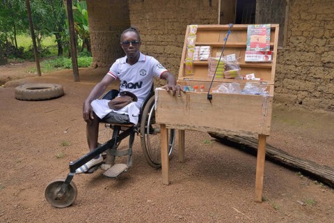 Amputee sitting in for his mobile shop, Motema Amputee Camp, Koidu, Koidu-Sefadu, Kono District,