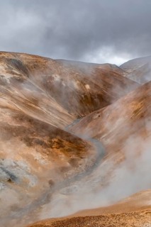 Steaming stream between colourful rhyolite mountains, Hveradalir geothermal area, Kerlingarfjöll,