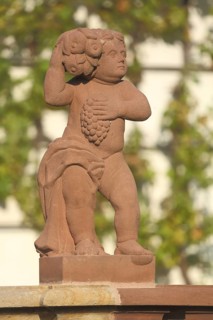 Red stone putto with grapes, detail, monastery complex, Seligenstadt, Main, Hesse, Germany, Europe