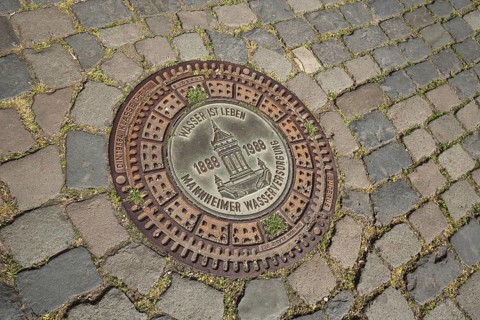 Manhole cover with inscription Water is life and water tower as landmark, Mannheim water supply,