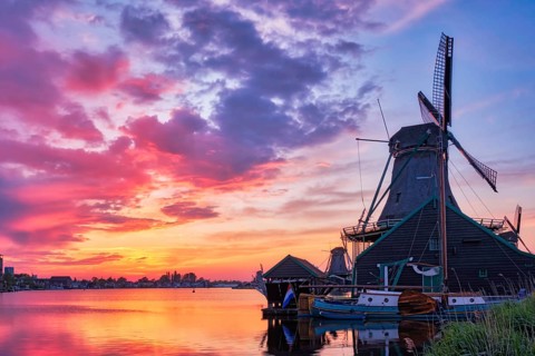 Netherlands rural scene, - windmills at famous tourist site Zaanse Schans in Holland on sunset with