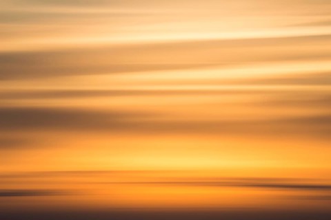 Orange-coloured evening sky with clouds near Lüneburg shortly after sunset, wiping effect, Lower