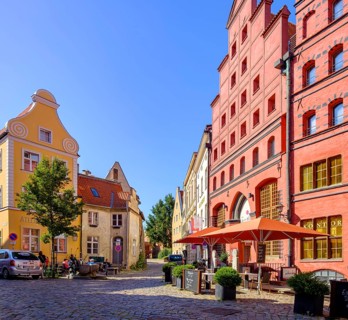 Street scene and historic building fabric with Gothic stepped gables and Baroque volute gables,