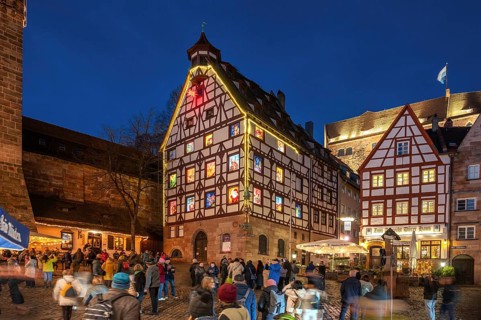 Historic Pilkatushaus with an Advent calendar on 18 December 2024 at dusk, behind the Imperial