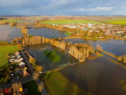 Aerial view of a suburb affected by flooding in the light of the setting sun, flood, Christmas,