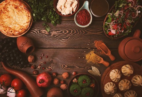 Traditional Georgian table, top view, Khinkali, Phali, Shoti, Khachapuri, Sauces, Fruits, nuts,