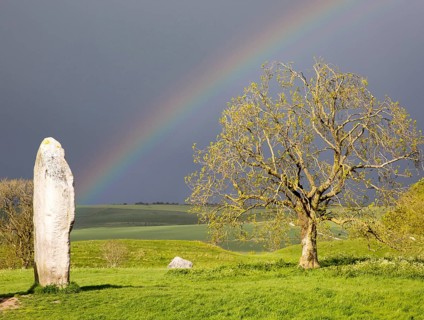 Rainbow over standing stones at Avebury, Wiltshire, England, UK