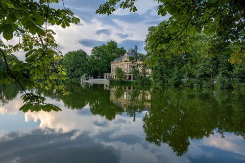 Seeschloss Monrepos is reflected in Lake Eglosheim, Ludwigsburg, Baden-Württemberg, Germany, Europe