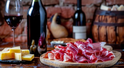 Wine, cured and smoked ham. Hamon iberico and prosciutto on a cutting board, AI generated