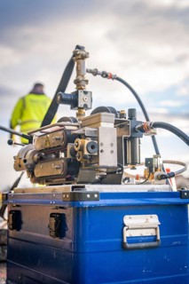 A close-up of a hydraulic gripper arm system in use, glass fibre construction, Nagold, Black