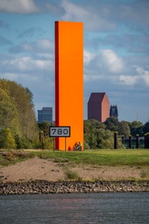 The sculpture Rhine Orange at the mouth of the Ruhr into the Rhine, skyline of the city centre of