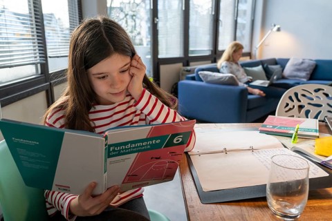 Homeschooling, during the lockdown in January 2021, children learning at home for school, a girl in