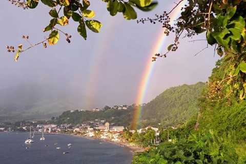 Double rainbow over beach and the town Saint-Pierre, first permanent French colony on the island of