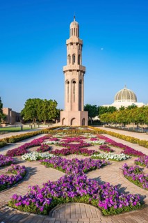 Sultan Qaboos Grand Mosque, minaret with blooming flowers in gardens, Muscat, Oman, Asia