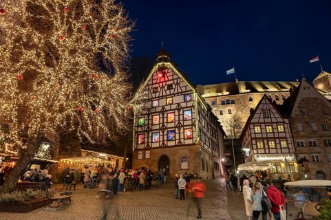 Historic Pilkatushaus with an Advent calendar on 18 December 2024 at dusk, behind the Imperial