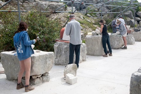 Sculptors working on local Portland stone in a community open air studio space at Tout Quarry, Isle