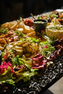 A table is beautifully arranged with a variety of Middle Eastern appetizers, featuring fresh herbs,