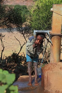 Amhara region, child drinking water at a well, Ethiopia, Africa