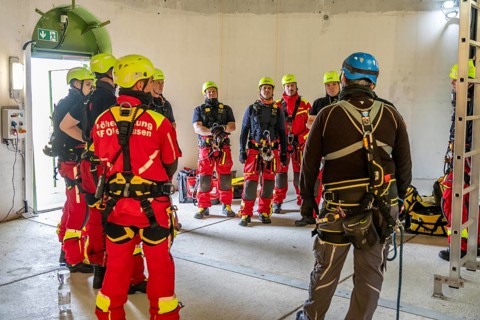 Height rescuers from the Oberhausen fire brigade practise abseiling from a wind turbine from a