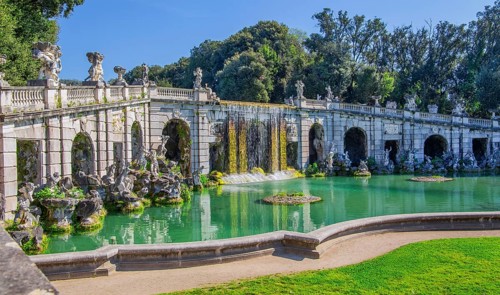 Fountain sculptures at the water basins in the garden of the royal palace Palazzo Reale, Italian