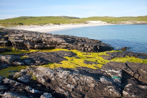 Rocky headland and sandy beach at Bagh a Deas, South Bay, Vatersay island, Barra, Outer Hebrides,