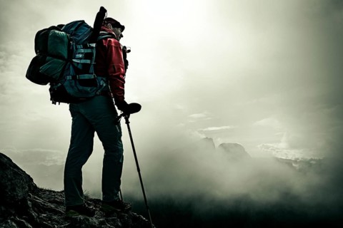 Mountaineer with luggage in the background Rätikon mountains with cloudy sky, Tschagguns, Rätikon,
