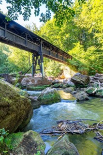 The Irrel Waterfalls, rapids in the lower reaches of the Prüm, covered wooden bridge for hikers,