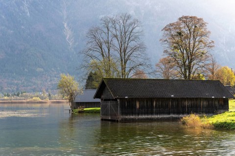 Lake Hallstatt near Steeg. Some boathouses. Autumn, backlight. Lake Hallstatt, Salzkammergut, Upper