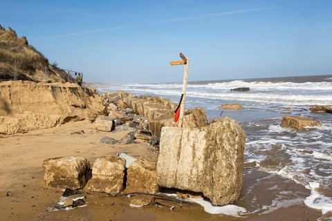 March 20 2018 Hemsby, UK. Coast path sign left abandoned by coastal erosion at Hemsby, Norfolk,