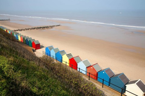 Colourful beach huts, wide sandy beach and sea, Mundesley, Norfolk, England, United Kingdom, Europe