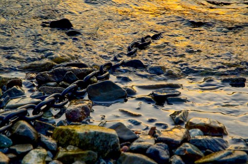 Metal Chain in the Water with Stones in Switzerland