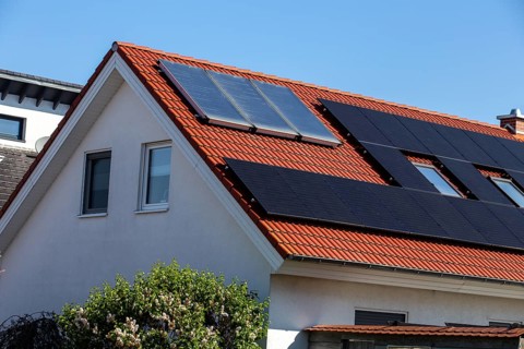Detached house with photovoltaic system and collectors for solar thermal energy