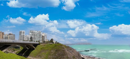 Peru, Lima, scenic ocean view and Miraflores Malecon promenade with shopping malls cafes and