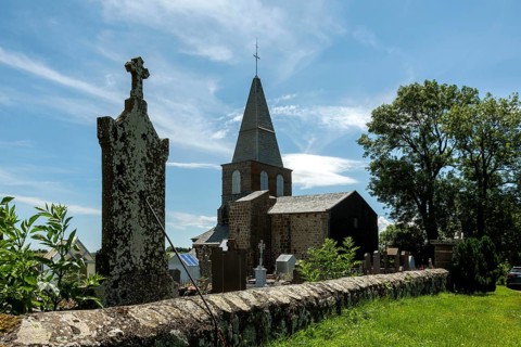 Cemetery of Saint-Victor la Rivière near the church under a clear blue sky in Puy-de-Dôme, Auvergne