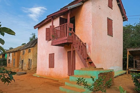 Traditional Malagasy two-story houses in street of rural village in the Ambositra District,