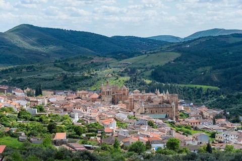 A historic town nestled in a hilly landscape on a clear day with clouds and blue sky, Guadalupe,
