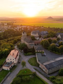 Aerial view of a castle at sunset, with a village and scenic background, Allstedt, Harz, Germany,