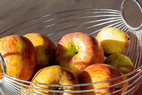 Close-up of apples and pears in the fruit basket