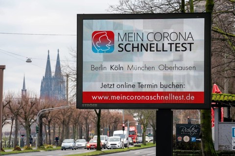 LED billboard, with digital advertising for Corona rapid tests, in the test centre in Cologne, on