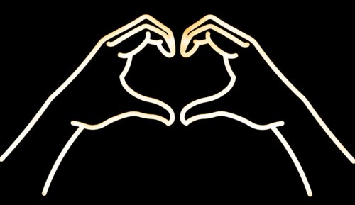 Electric neon lights of hands forming heart shape, Marlborough, Wiltshire, England, UK