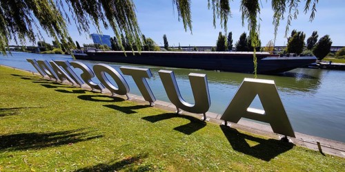 Lettering Autostadt am Mittellandkanal with passing barge, Wolfsburg, Lower Saxony, Germany, Europe