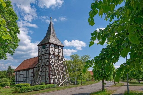 Half-timbered church in Wenze, stabilised against collapse with squared timbers, in the UNESCO