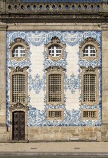 The facade of Igreja do Carmo church, adorned with intricate blue and white tiles, Porto, Portugal,