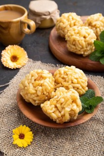 Traditional Tatar candy chak-chak made of dough and honey with cup of coffee on a black concrete