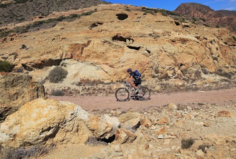 Person cycling in Cabo de Gata national park, Monsul, near San José, Almeria, Spain, Europe
