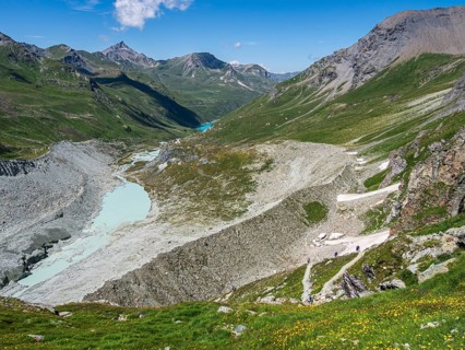 Hiking trail up to mountain hut Cabane de Moiry, glacial moraine, lake Lac de Moiry in the back,